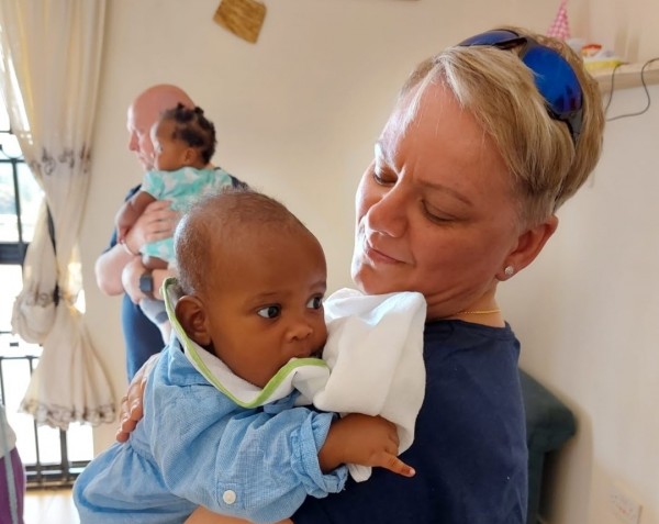 Paula Holmes Patel with baby on mission trip