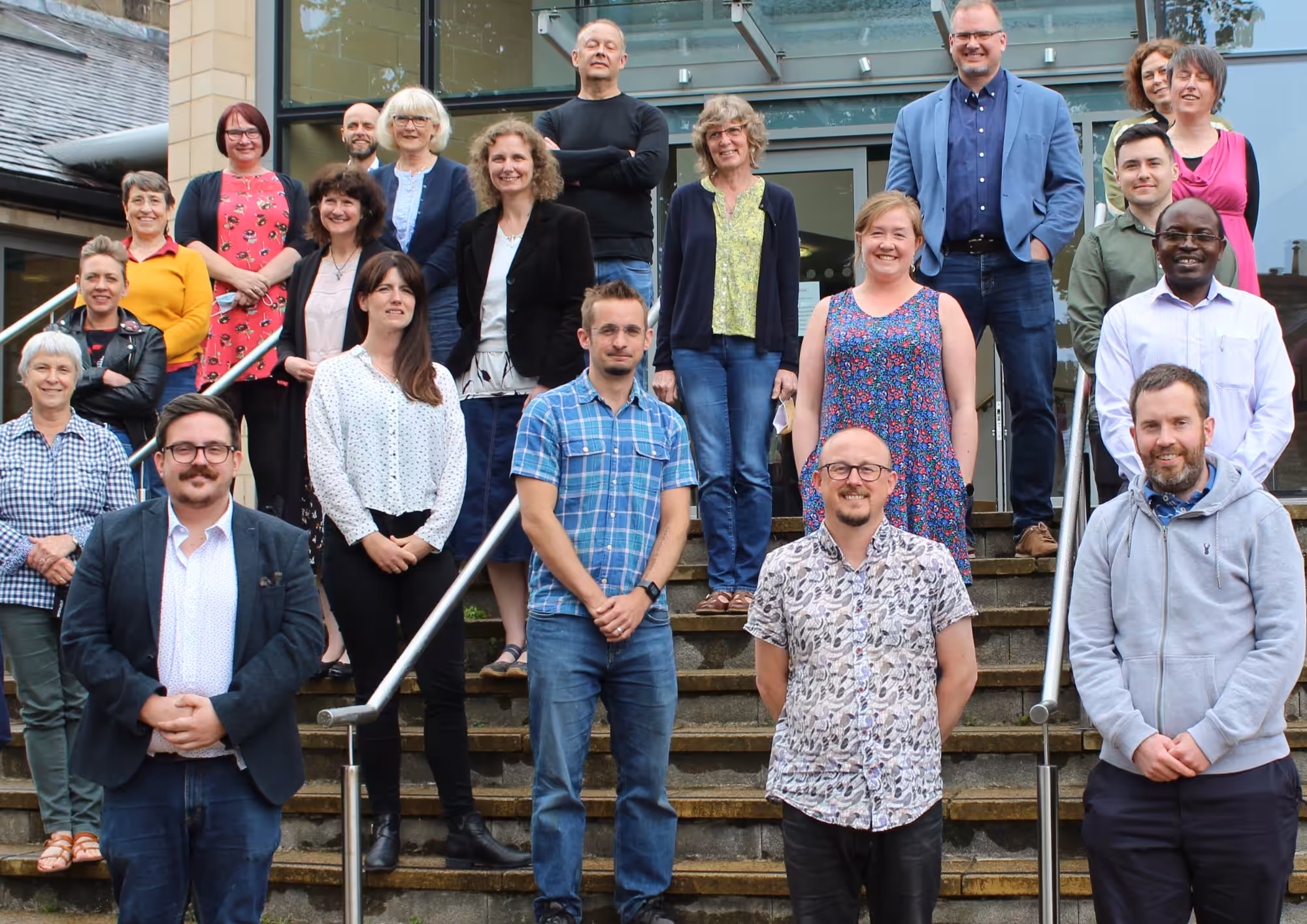 A photo of the St Hild team standing on the steps of St Hild Sheffield