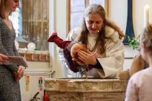 Rebecca Rock baptising an infant